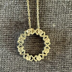 Elegant Gold Circle Pendant Necklace with X O Meaning hugs and kisses.